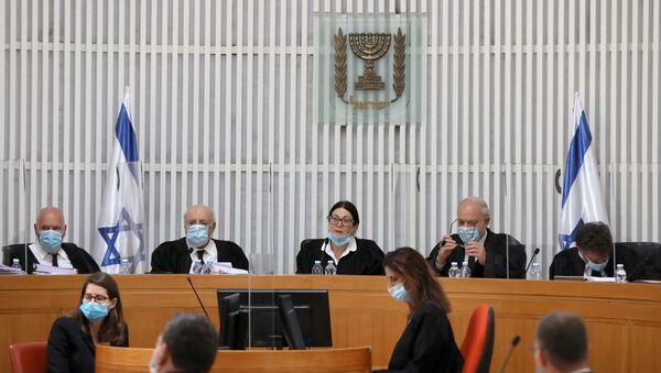 A panel of judges of the Israeli Supreme Court wear face masks as they address a discussion on a petition asking whether Israeli Prime Minister Benjamin Netanyahu can form a government legally and publicly when indictments are filed against him on a charges of fraud, bribery, and breach of trust, at the Israeli Supreme Court in Jerusalem 4 May 2020. - Sputnik International