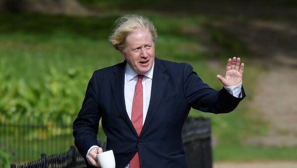 Britain's Prime Minister Boris Johnson waves as he goes for a walk in Central London following the outbreak of the coronavirus disease (COVID-19), London, Britain May 11, 2020. REUTERS/Toby Melville - Sputnik International