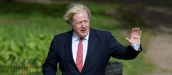 Britain's Prime Minister Boris Johnson waves as he goes for a walk in Central London following the outbreak of the coronavirus disease (COVID-19), London, Britain May 11, 2020. REUTERS/Toby Melville - Sputnik International