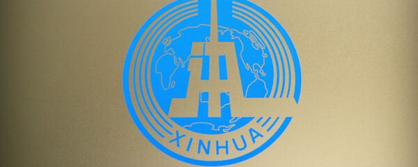 Logo of China's Xinhua News Agency is seen on a glass partition at the agency's newsroom in Beijing. File photo. - Sputnik International