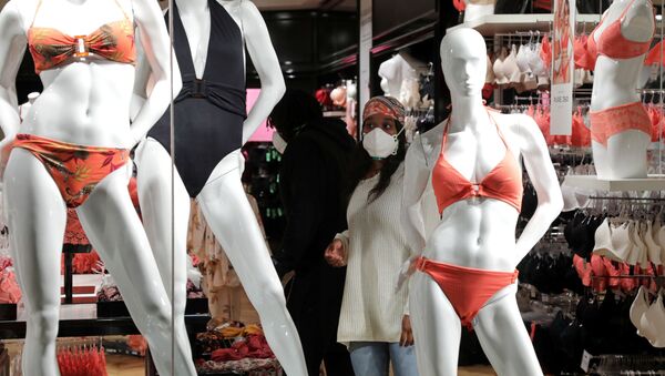 A woman wearing a protective face mask looks at bathing suits in a Cap 3000 department store in Saint Laurent du Var near Nice as France softens strict lockdown rules put in place to deal with the outbreak of the coronavirus disease (COVID-19), 11 May 2020.  - Sputnik International