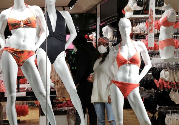 A woman wearing a protective face mask looks at bathing suits in a Cap 3000 department store in Saint Laurent du Var near Nice as France softens strict lockdown rules put in place to deal with the outbreak of the coronavirus disease (COVID-19), 11 May 2020.   - Sputnik International