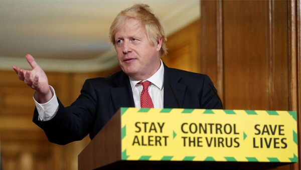 A handout image released by 10 Downing Street, shows Britain's Prime Minister Boris Johnson, standing behind a podium featuring the Government's new slogan Stay Alert, Control the Virus, Save Lives, as he attends a remote press conference to update the nation on the COVID-19 pandemic, inside 10 Downing Street in central London on May 11, 2020. - The British government on Monday published its plan to ease the nationwide coronavirus lockdown in phases in England, with some schools and shops opening from June and recommending people wear face masks in some settings. - Sputnik International