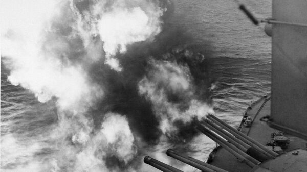Mushrooms of smoke and flame billow out from the giant USS Nevada as the battleship provides artillery support for Allied ground forces in France by hammering enemy installations from her vantage point in the English Channel, June 6, 1944. - Sputnik International