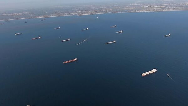 Some of the 27 oil tankers anchored off shore during the outbreak of the coronavirus disease (COVID-19) are viewed from a U.S. Coast Guard helicopter near Long Beach, California, U.S., in a still image from video taken April 23, 2020 - Sputnik International