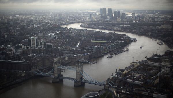 Tower Bridge, centre, and Canary Wharf in the distance with the Thames flowing through London, are seen through a window during the official opening of The View  - a viewing platform at the 95-storey Shard skyscraper in London, Friday, 1 February 2013. - Sputnik International