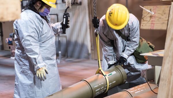Two operators work together to place one of the last overpacked 8-inch projectiles containing nerve agent into a tray to begin the destruction process at the Blue Grass Chemical Agent-Destruction Pilot Plant May 9. The last GB 8-inch projectile was destroyed May 11, marking the complete destruction of an entire type of chemical weapon. - Sputnik International