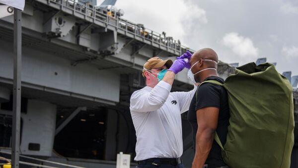 U.S. Navy sailors assigned to aircraft carrier USS Theodore Roosevelt, who have tested negative twice for coronavirus disease (COVID-19), are asymptomatic and completed their off-ship quarantine or isolation, prepare to board the clean ship at Naval Base Guam May 1, 2020 - Sputnik International