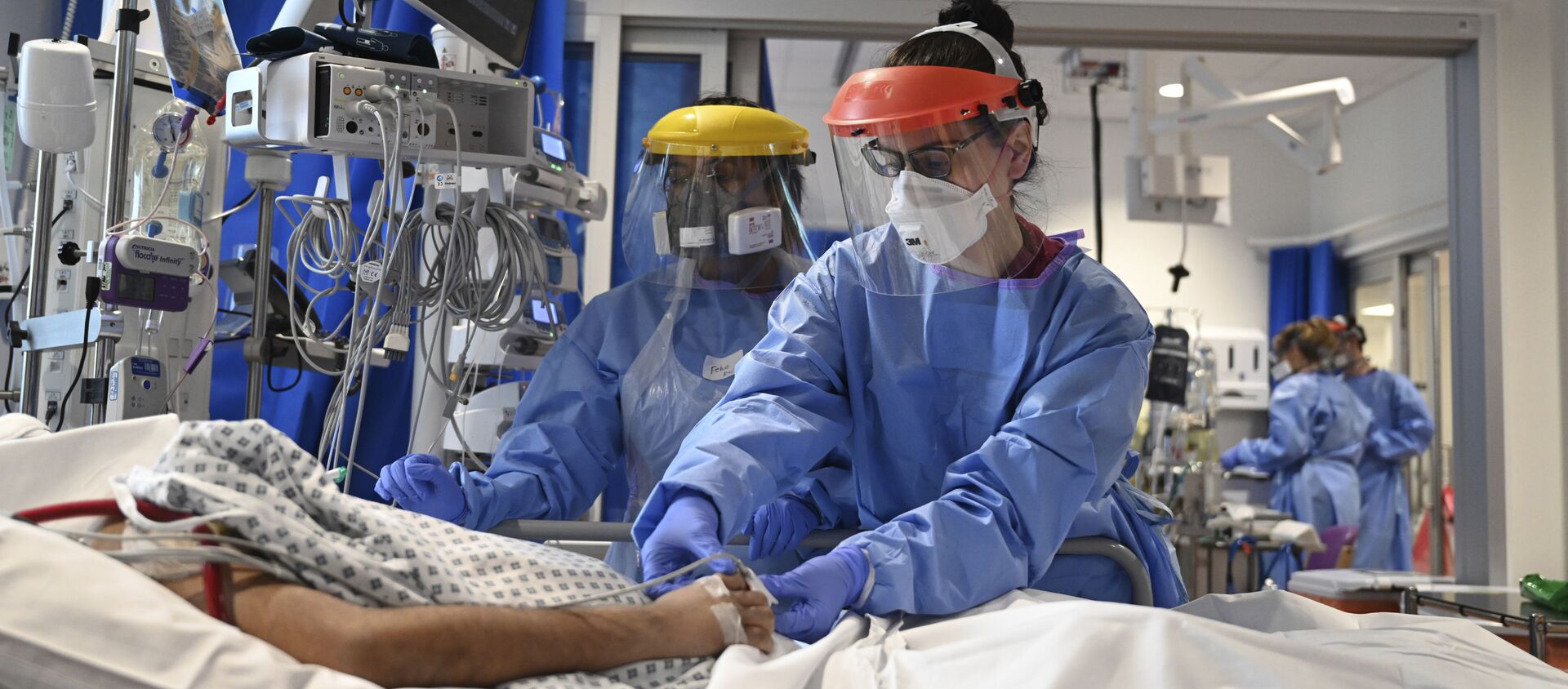 Members of the clinical staff wearing Personal Protective Equipment PPE care for a patient with coronavirus in the intensive care unit at the Royal Papworth Hospital in Cambridge, 5 May 2020 - Sputnik International, 1920, 22.04.2021