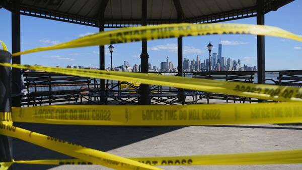 Police tape reading Do Not Cross is wrapped around a gazebo with view of lower Manhattan and One World Trade Center on April 22, 2020 in Hoboken, New Jersey. - The World Health Organization on April 22, warned that the coronavirus crisis would not end any time soon, with many countries only in the early stages of the fight, as the global death toll surpassed 180,000 - Sputnik International