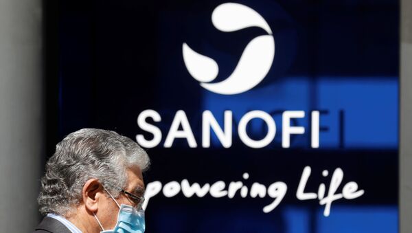 A man wearing a protective face mask walks past the logo of Sanofi at the company's headquarters in Paris, France, April 24, 2020. R - Sputnik International