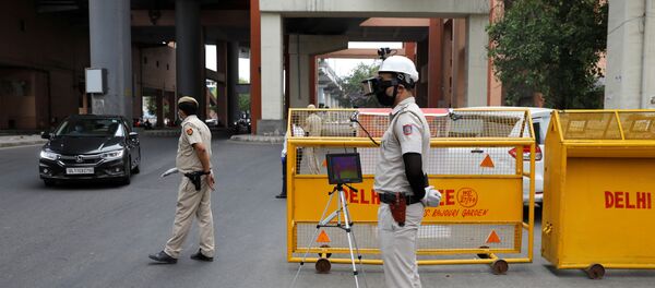 A police officer wears a Thermal Corona Combat Headgear to monitor the temperature of commuters at a police check post, during a nationwide lockdown to slow the spread of the coronavirus disease (COVID-19), in New Delhi, India May 11, 2020. A police officer wears a Thermal Corona Combat Headgear to monitor the temperature of commuters at a police check post, during a nationwide lockdown to slow the spread of the coronavirus disease (COVID-19), in New Delhi, India May 11, 2020. - Sputnik International