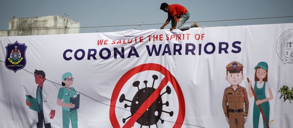 A worker installs a hoarding thanking frontline workers during a nationwide lockdown to slow the spreading of the coronavirus disease (COVID-19), in Ahmedabad, India, A worker installs a hoarding thanking frontline workers during a nationwide lockdown to slow the spreading of the coronavirus disease (COVID-19), in Ahmedabad, India, - Sputnik International