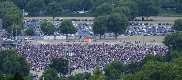 Participants take part in a rally against coronavirus restrictions, at the Cannstatter Wasen, in Stuttgart - Sputnik International