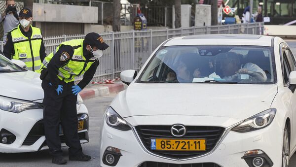 Israeli police stop a vehicle at a checkpoint in Bnei Barak, a city east of Tel Aviv with a significant ultra-Orthodox Jewish population, on April 2, 2020, as part of measures imposed by Israeli authorities against the COVID-19 coronavirus pandemic - Sputnik International
