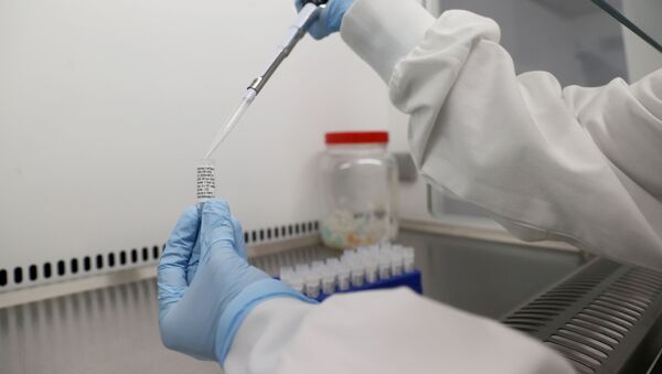 Scientists are seen working at Cobra Biologics, they are working on a potential vaccine for COVID-19, following the outbreak of the coronavirus disease (COVID-19), in Keele, Britain, April 30, 2020 - Sputnik International