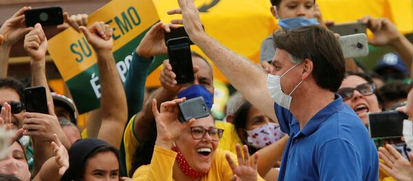 Brazil's President Jair Bolsonaro greets supporters during a protest against the President of the Chamber of Deputies Rodrigo Maia, Brazilian Supreme Court, quarantine and social distancing measures, amid the coronavirus disease (COVID-19) outbreak, in Brasilia, Brazil May 17, 2020 - Sputnik International