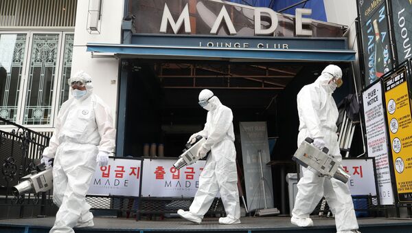 Quarantine worker sprays disinfectants in front of a night club on the nightspots in the Itaewon neighborhood, following the coronavirus disease (COVID-19) outbreak, in Seoul, South Korea, 12 May 2020. - Sputnik International