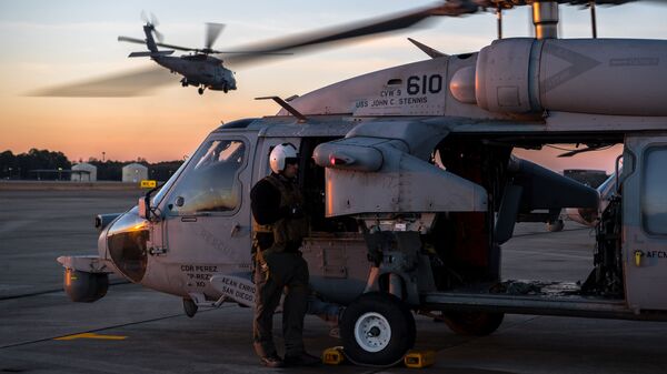 A U.S. Navy MH-60S Seahawk aircrew member, assigned to the Helicopter Sea Combat Squadron 14, prepares for a close air support training scenario during Southern Strike 2020 at the Gulfport Combat Readiness Training Center, Miss., Feb. 2, 2020 - Sputnik International