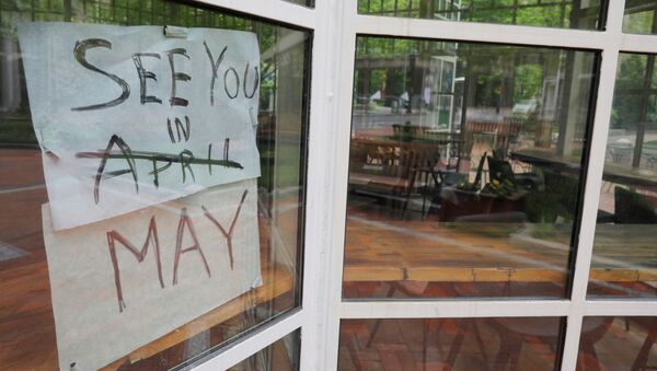 The sign on Sip Cafe reads See you in May, with April crossed out, amid the coronavirus disease (COVID-19) outbreak in Boston, Massachusetts, U.S., May 18, 2020.    - Sputnik International