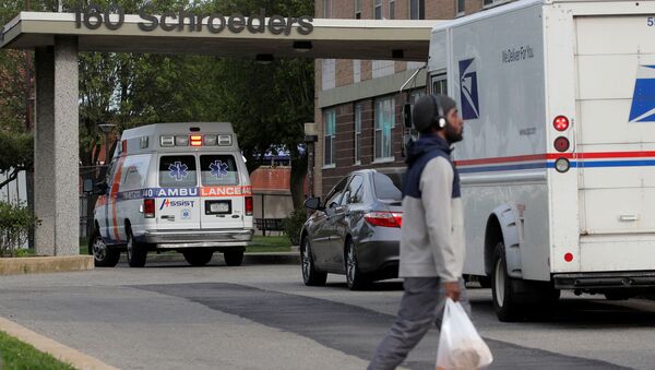 An ambulance is parked outside a building, during the outbreak of the coronavirus disease (COVID-19), in the Starrett City neighborhood in the Brooklyn borough of New York, City, New York U.S., May 18, 2020. - Sputnik International