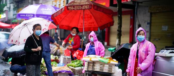 People wearing protective face masks are seen at a street market in Wuhan, the Chinese city hit the hardest by the coronavirus disease (COVID-19) outbreak, in the Hubei province, China, May 14, 2020. People wearing protective face masks are seen at a street market in Wuhan, the Chinese city hit the hardest by the coronavirus disease (COVID-19) outbreak, in the Hubei province, China, May 14, 2020. - Sputnik International