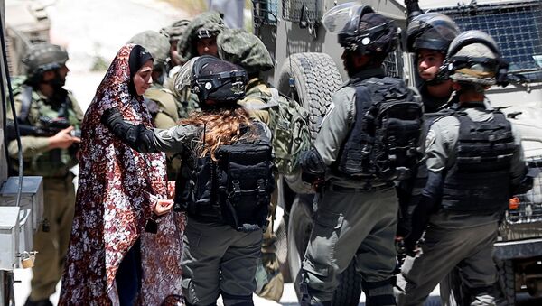 A Palestinian woman cries as she is stopped by Israeli forces after an Israeli soldier was killed by a rock thrown during an arrest raid, in Yabad near Jenin in the Israeli-occupied West Bank May 12, 2020 - Sputnik International