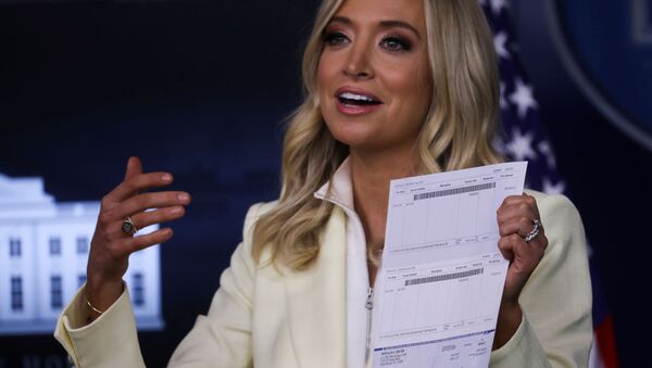 White House Press Secretary Kayleigh McEnany holds up a check signed by U.S. President Donald Trump for $100,000 made out to the Office of the Assistant Secretary for Health as she states that the president is donating his presidential salary to the Department of Health and Human Services, in the Brady Press Briefing Room at the White House in Washington, U.S., May 22, 2020 - Sputnik International