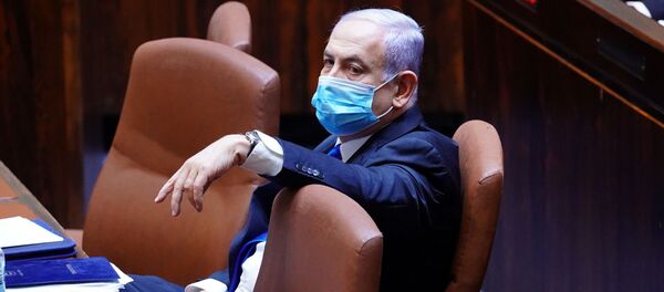 Israeli Prime Minister Benjamin Netanyahu wears a mask during a swearing in ceremony of his new unity government with election rival Benny Gantz, at the Knesset, Israel's parliament, in Jerusalem May 17, 2020.  - Sputnik International
