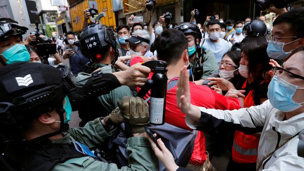 Anti-government demonstrators scuffle with riot police during a lunch time protest as a second reading of a controversial national anthem law takes place in Hong Kong, China May 27, 2020. - Sputnik International