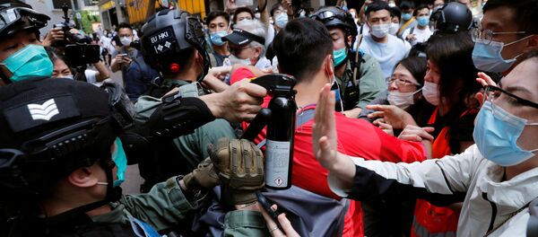 Anti-government demonstrators scuffle with riot police during a lunch time protest as a second reading of a controversial national anthem law takes place in Hong Kong, China May 27, 2020. Anti-government demonstrators scuffle with riot police during a lunch time protest as a second reading of a controversial national anthem law takes place in Hong Kong, China May 27, 2020. - Sputnik International