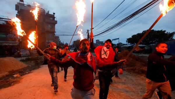 Students with torches protest against the alleged encroachment of Nepal border by India in far west of Nepal, during the 49th day of a lockdown imposed by the government amid concerns about the spread of the coronavirus disease (COVID-19), in Kathmandu, Nepal May 11, 2020 - Sputnik International