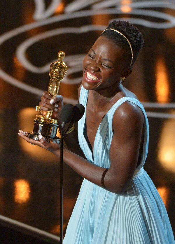 In this March 2, 2014 file photo, Lupita Nyong’o accepts the award for best actress in a supporting role for 12 Years a Slave during the Oscars in Los Angeles. - Sputnik International