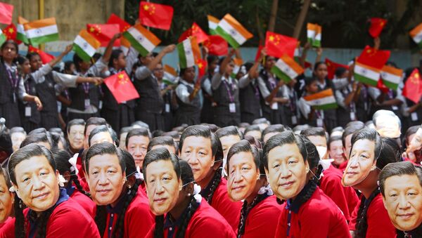  File photo of students wearing masks of China's President Xi Jinping as others wave national flags of India and China, ahead of the informal summit with India’s Prime Minister Narendra Modi, at a school in Chennai, India, October 10, 2019 - Sputnik International