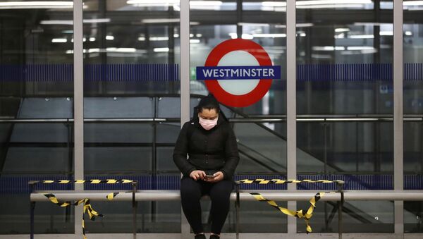 A woman wearing a protective face mask is seen at Westminster tube station, following the outbreak of the coronavirus disease (COVID-19), London, Britain, May 11, 2020. - Sputnik International