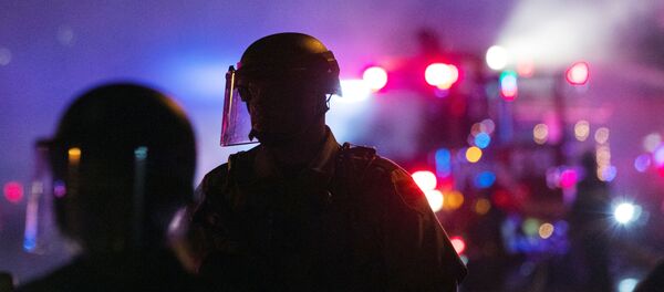Minneapolis Police Department officers watch protesters during continued demonstrations against the death in Minneapolis police custody of African-American man George Floyd, in Minneapolis, Minnesota, 30 May 2020 - Sputnik International