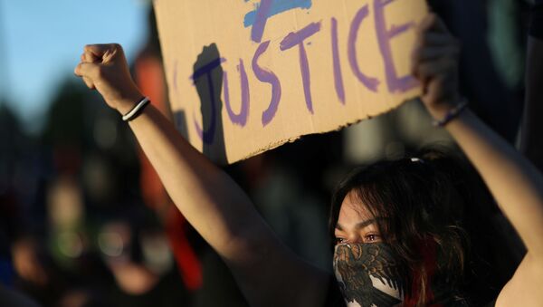A protester holds a sign as protesters continue to rally against the death in Minneapolis police custody of George Floyd, in Minneapolis, Minnesota, U.S. May 30, 2020. - Sputnik International