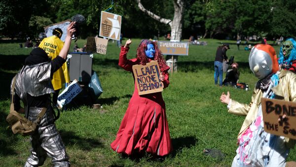 Dressed-up counter protestors pose with signs as people demonstrate against the government's restrictions following the coronavirus disease (COVID-19) outbreak, at Mauerpark in Berlin, Germany, May 30, 2020. - Sputnik International