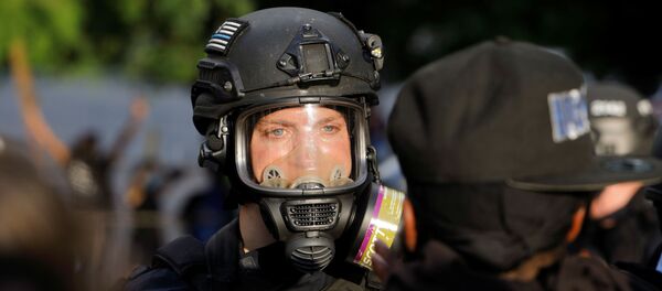A policeman faces a protester during nationwide unrest following the death in Minneapolis police custody of George Floyd, in Raleigh, North Carolina, U.S. May 30, 2020 - Sputnik International