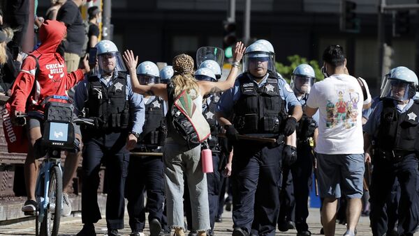 A person raises up their arms while blocking Chicago Police officers during a protest over the death of George Floyd in Chicago, Saturday, May 30, 2020 - Sputnik International