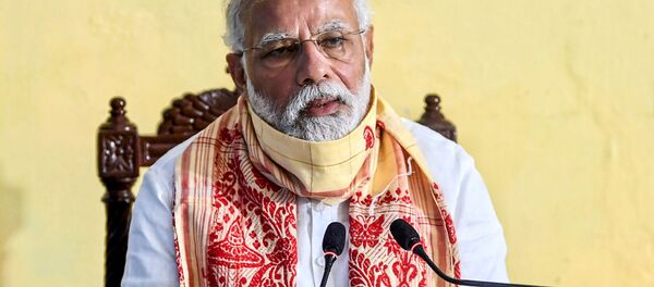 In this handout photograph taken on May 22, 2020 and released by the Indian Press Information Bureau (PIB), India's Prime Minister Narendra Modi speaks during a review meeting with officials after his aerial survey of affected areas in the state from cyclone Amphan, in Basirhat, West Bengal. In this handout photograph taken on May 22, 2020 and released by the Indian Press Information Bureau (PIB), India's Prime Minister Narendra Modi speaks during a review meeting with officials after his aerial survey of affected areas in the state from cyclone Amphan, in Basirhat, West Bengal. - Sputnik International