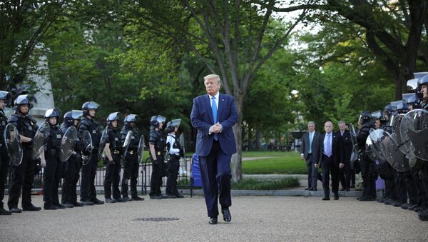 U.S. President Donald Trump walks between lines of riot police in Lafayette Park across from the White House after walking to St John's Church for a photo opportunity during ongoing protests over racial inequality in the wake of the death of George Floyd while in Minneapolis police custody, at the White House in Washington, U.S., June 1, 2020. - Sputnik International