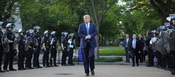 U.S. President Donald Trump walks between lines of riot police in Lafayette Park across from the White House after walking to St John's Church for a photo opportunity during ongoing protests over racial inequality in the wake of the death of George Floyd while in Minneapolis police custody, at the White House in Washington, U.S., June 1, 2020. - Sputnik International