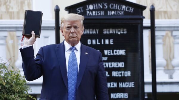 President Donald Trump holds a Bible as he visits outside St. John's Church across Lafayette Park from the White House Monday, June 1, 2020, in Washington. Park of the church was set on fire during protests on Sunday night. (AP Photo/Patrick Semansky) - Sputnik International