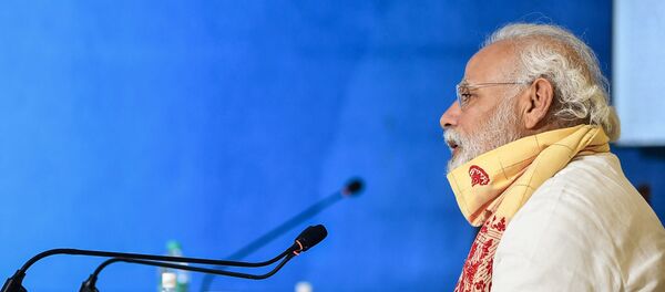 In this handout photograph taken on May 22, 2020 and released by the Indian Press Information Bureau (PIB), India's Prime Minister Narendra Modi speaks during a review meeting with officials after his aerial survey of affected areas in the state from cyclone Amphan, in Basirhat, West Bengal. - Sputnik International