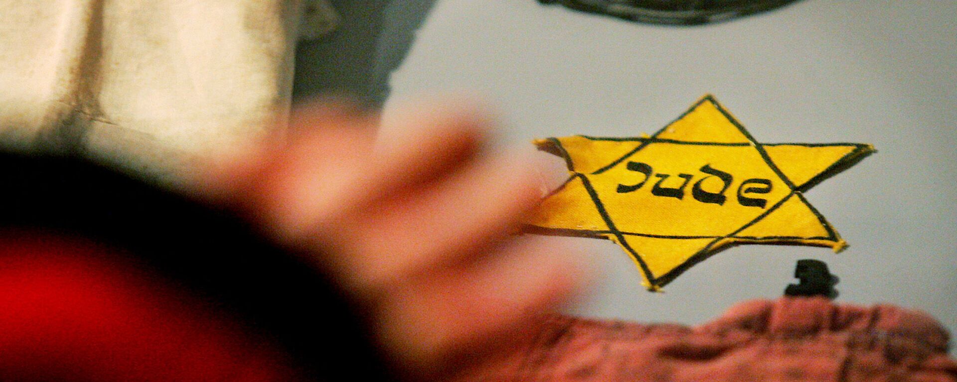 A yellow Star of David Jews were forced to wear by the Nazis, is seen with other belongings of holocaust survivors from the Auschwitz-Birkenau concentration camp that are on display at the Yad Vashem Holocaust Memorial in Jerusalem, Monday, Jan. 24, 2005 - Sputnik International, 1920, 15.03.2021