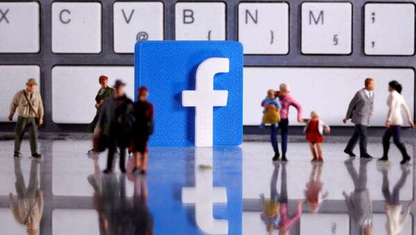  A 3D printed Facebook logo is placed between small toy people figures in front of a keyboard in this illustration taken April 12, 2020 - Sputnik International