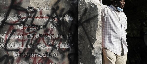 Robert Walker poses for a photograph on the remains of a Confederate memorial that was removed overnight in Birmingham, Ala., on Tuesday, June 2, 2020 Robert Walker poses for a photograph on the remains of a Confederate memorial that was removed overnight in Birmingham, Ala., on Tuesday, June 2, 2020 - Sputnik International