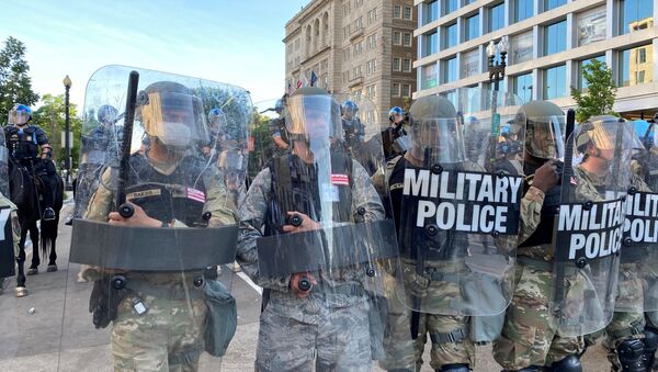 Washington, D.C. National Guard military police block a street near the White House from protestors as the number of U.S. military forces deployed to the streets of the nation's capital increases, while protests continue against the death in Minneapolis police custody of George Floyd, in Washington, U.S., June 1, 2020.  - Sputnik International