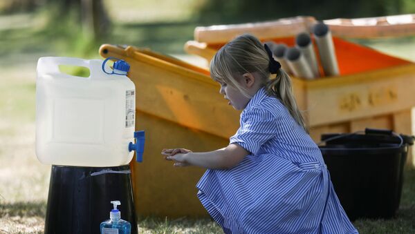 A child washes her hands after playing at St Dunstan's College junior school as some schools re-open following the outbreak of the coronavirus disease (COVID-19) in London, Britain June 1, 2020. - Sputnik International